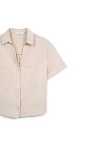 Camicetta a manica corta di un leggero color beige con bottoni, realizzata in tessuto texturizzato, con colletto, due tasche frontali e una vestibilità rilassata.