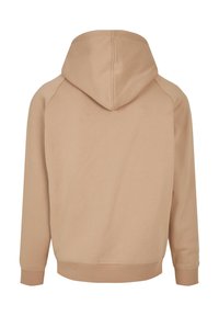 Beige katoenen hoodie met een kangoeroezak, ribgebreide mouwen en zoom. Beschikt over een capuchon en een gladde textuur met een relaxte pasvorm.
