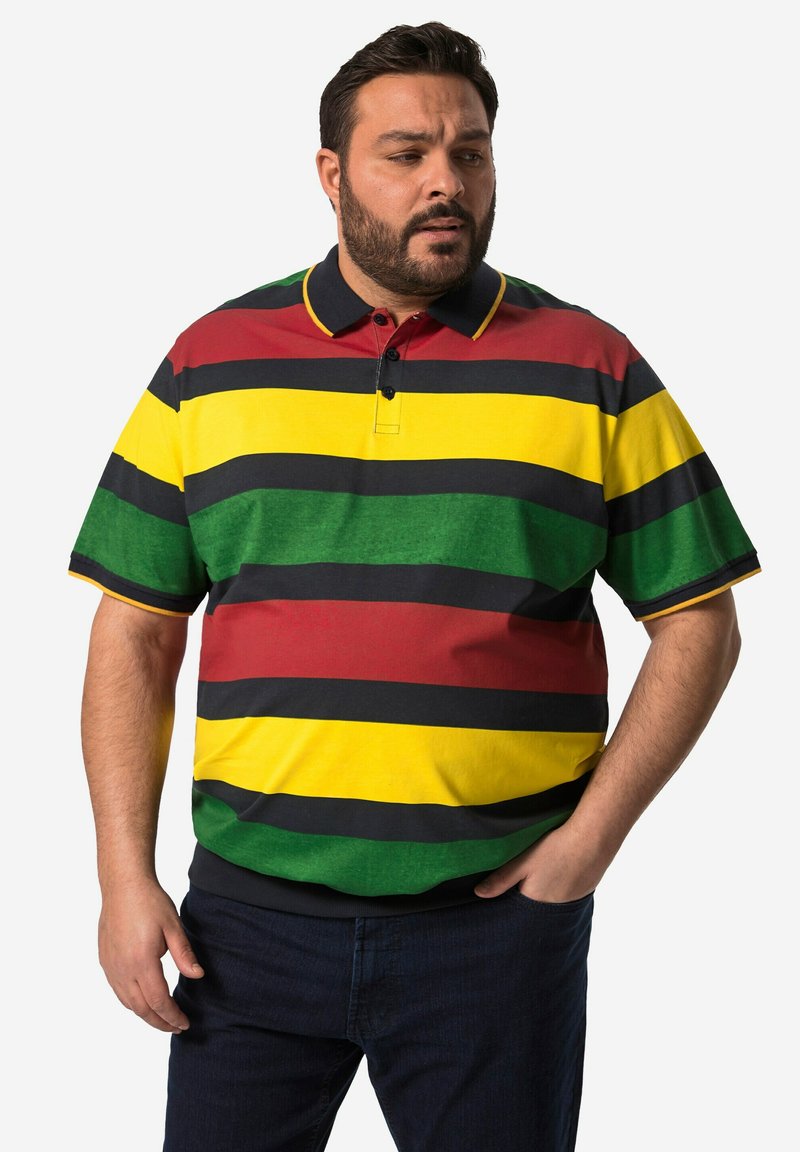 Pruhovaný polo tričko s červenými, žlutými, zelenými a černými vodorovnými pruhy, s límcem a dvoubotkovým zapínáním. Materiál se zdá být bavlněný.