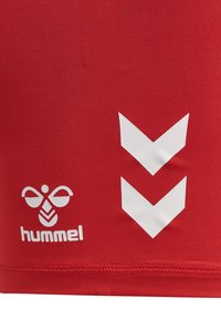 Red fabric with white hummel brand logo featuring a stylized bee and two downward-pointing chevron arrows.
