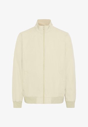 Bež jopica z zadrgo, rebrastimi manšetami in robom, dvema stranskima žepoma ter visokim ovratnikom, prikazana razprostrta na belem ozadju.