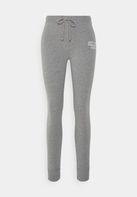 Grå sweatpants i mjuk tyg, med dragsko i midjan, tajta ankelfåttor och broderad "HOLLISTER"-logotyp på framsidan.
