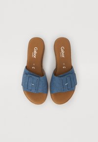 Flat slide sandals with a denim upper featuring a decorative strap and a brown, textured footbed. Brand name "Gabor" printed inside.