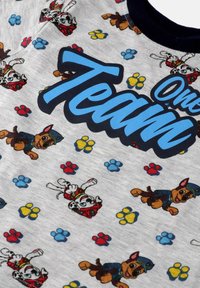 Gray cotton t-shirt featuring colorful cartoon dog characters and paw prints, with blue "One Team" text in a playful font.