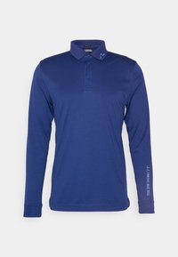 Pánská polo košile s dlouhým rukávem v námořnické modři, vyrobená z kombinace bavlny, s límečkem na dva knoflíky a logem na rukávu.