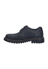 Scarpa di pelle nera con punta arrotondata, superficie testurizzata, cuciture bianche a contrasto e una suola in gomma spessa con un motivo a tasselli.