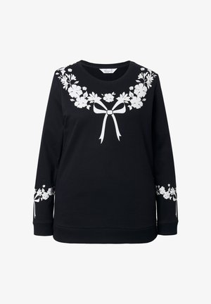 Zwarte sweatshirt met witte bloemmotieven en strikmotieven op de borst en mouwen. Gemaakt van zacht materiaal, met een ronde halslijn en lange mouwen.