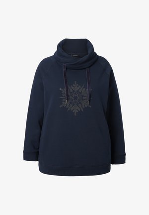 Navy fleece-paita leuan ympäri, jossa on hopeinen lumihiutalesuunnittelu, joka on tehty napeista. Ribbetyt hihansuut ja helma lisäävät tekstuuria.