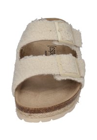 Cream-colored sandals with two adjustable straps, fuzzy texture, soft lining, and a cork footbed. Notable for their flat, platform sole.