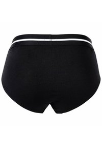 Slip da uomo in cotone nero con una superficie liscia, caratterizzati da una fascia larga in vita con una striscia bianca e un design semplice e minimalista.