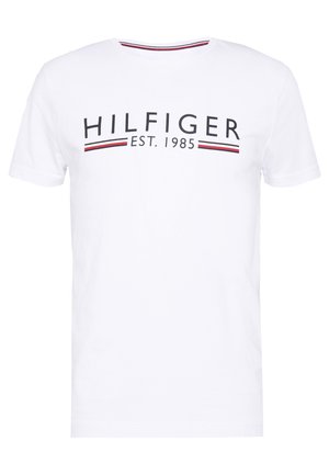 White cotton t-shirt featuring a crew neck, short sleeves, and a printed logo with red and navy stripes below the text "HILFIGER EST. 1985."