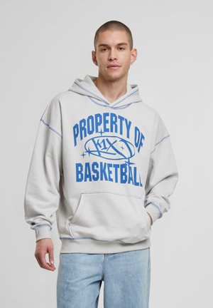 Light grey hoodie with blue "PROPERTY OF BASKETBALL" text, kangaroo pocket, ribbed cuffs, and hood with contrasting stitching details.
