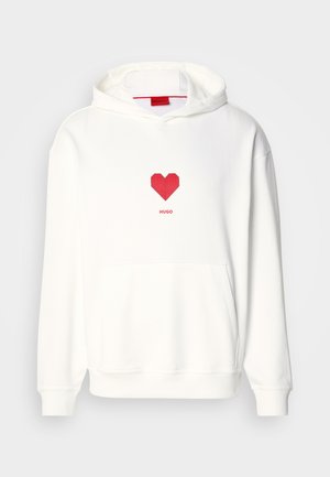 White hooded sweatshirt with red heart graphic and "HUGO" text. Features front pocket, ribbed cuffs, and soft texture. Simple design.