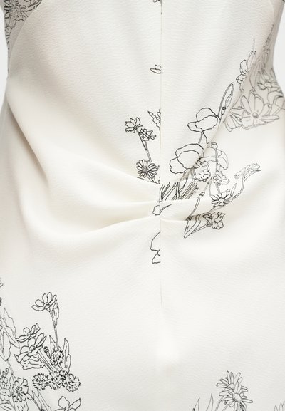 Λευκό ύφασμα με φλοράλ σχέδιο σε μαύρες περιγράμματα. Το υλικό έχει ελαφρώς υφή με πιέτες στη μέση.
