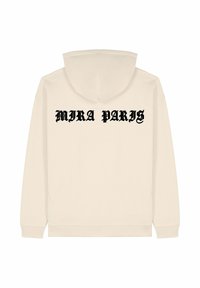 Felpa beige con stampa nera "MIRA PARIS" sulla schiena. Realizzata in tessuto morbido, ha una vestibilità rilassata e maniche lunghe standard.
