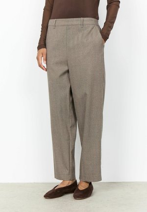 Person wearing high-waist, wide-leg taupe trousers with side pockets and dark brown flat shoes against a plain white background.