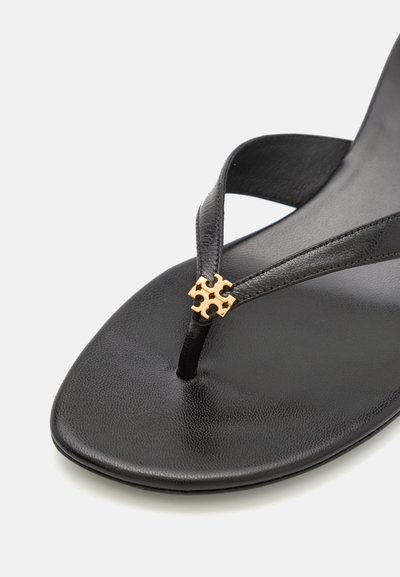 Black flip-flop sandal featuring textured leather straps and a gold accent detail at the center. Flat sole with a smooth finish.