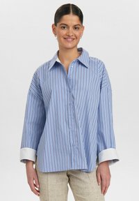 Blue and white striped shirt with a large collar, button-up front, and rolled-up cuffs. Soft fabric with a relaxed fit design.
