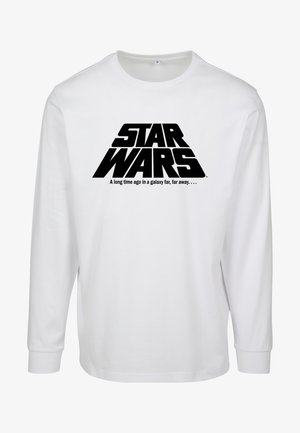 Valge pikalt varrukatega T-särk, millel on suur must "STAR WARS" logo ja tekst: "Kaugel, kaugel ajas, kauges galaktikas..."