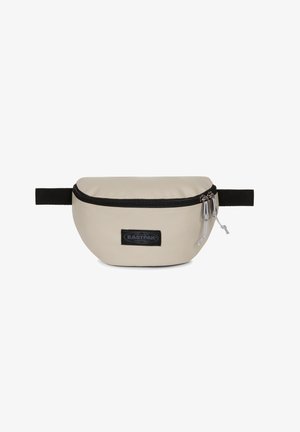Kermavan värinen soikea vyölaukku, joka on valmistettu pehmeästä synteettisestä materiaalista. Laukussa on musta vetoketjusuljenta ja musta Eastpak-logo.