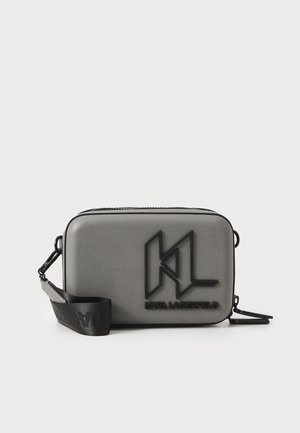 Compact rectangular gray crossbody bag with black "KL" logo and "Karl Lagerfeld" text, and an adjustable black strap with clips.