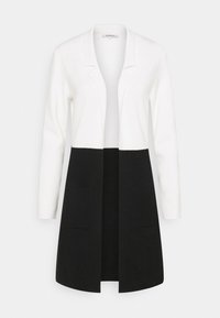 Knit cardigan featuring a white upper section and black lower section, with a lapel collar and two front pockets. Smooth texture.