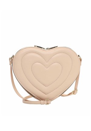 Beige heart-shaped crossbody bag with quilted heart patterns, gold-tone zipper, and adjustable strap on a white background.