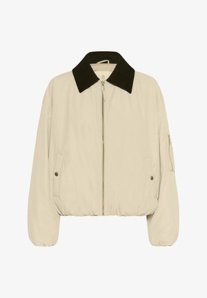 Beige színű, cipzáros bomber dzseki sötétbarna kordbársony gallérral, elasztikus mandzsettákkal és aljjal, patentos zsebekkel és ujjzseb zippel.