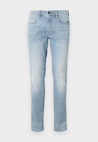 Jeans de mezclilla de un azul claro con un corte ajustado, que cuentan con cremallera, cinco bolsillos y un lavado deslavado para un aspecto casual.
