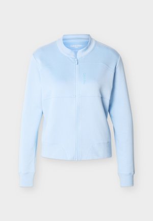 Helehall sinine mõnus lukuga jakk soonikkoes mansettide ja kraega, rinnal peen Calvin Kleini logo, sile kangas ning vormitud siluett.