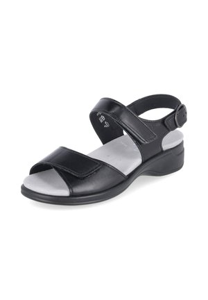 Black open-toe sandal with adjustable straps over the foot and around the ankle, cushioned silver-gray insole, and low supportive heel.