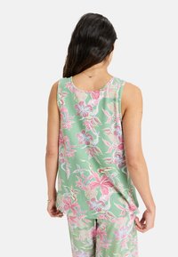 Light green tank top with pink floral pattern, round neckline, and sleeveless design; fabric appears soft and lightweight.