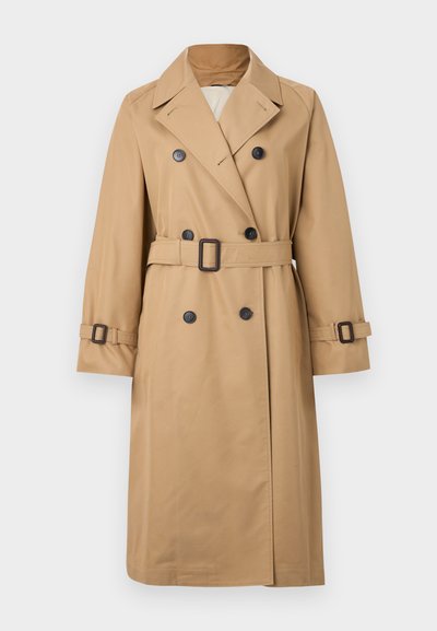 Beige trench coat with a double-breasted design, black buttons, belt at the waist, and adjustable cuffs. Smooth texture, classic silhouette.