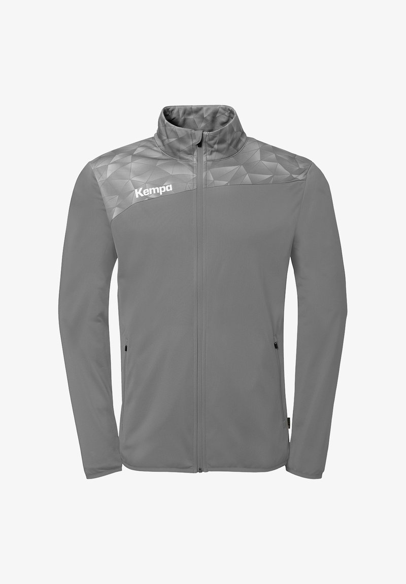 Veste de sport grise zippée avec motif géométrique sur les épaules et logo "Kempa" sur la poitrine gauche, comprenant deux poches latérales zippées.