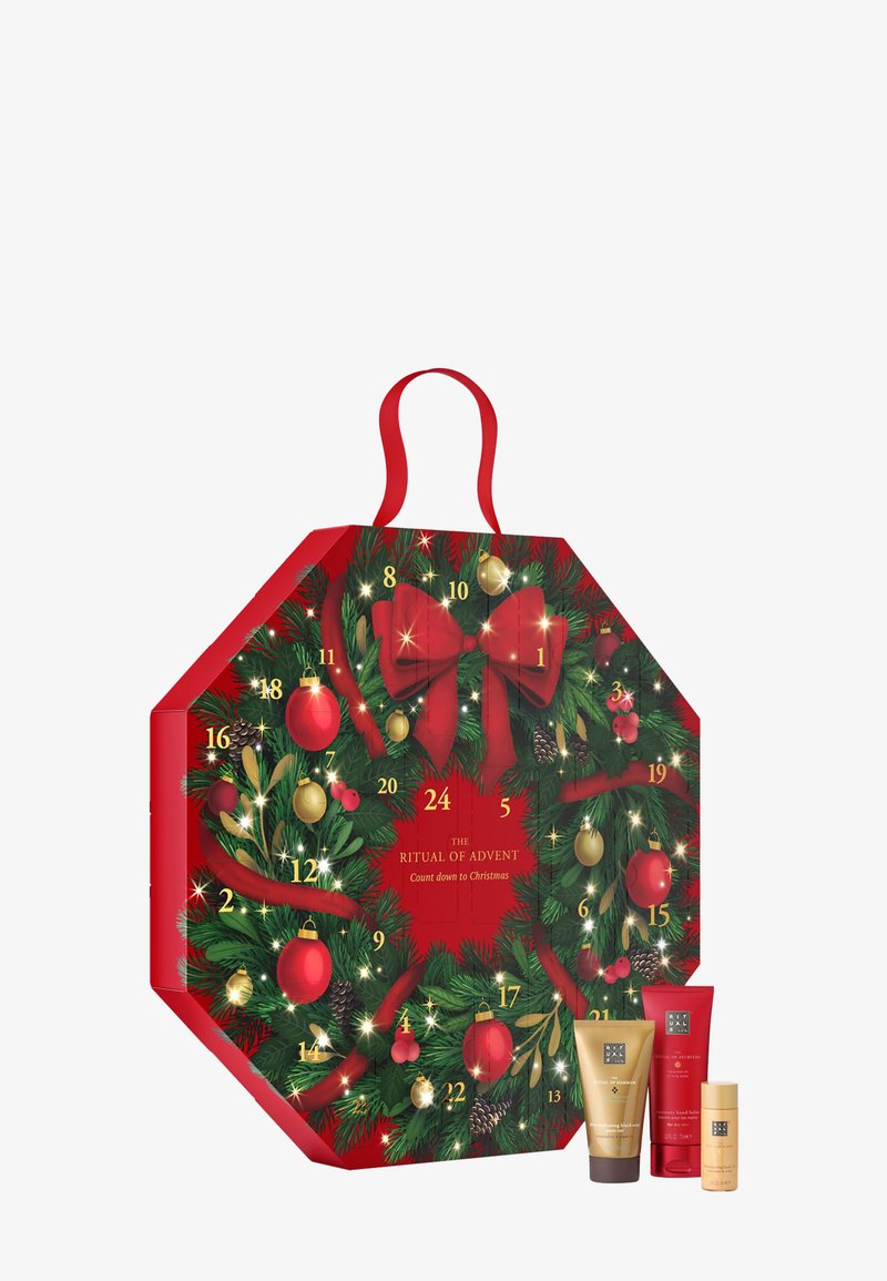 Calendrier de l'Avent octogonal rouge décoré de sapin, d'ornements et d'un nœud. Comprend des portes numérotées et inclut trois produits cosmétiques à la base.