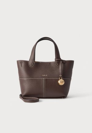 Dark brown textured leather handbag with double handles, white stitching, gold round charm, and small logo on front.