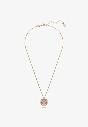 Collar de oro rosa con un colgante en forma de corazón adornado con múltiples piedras brillantes y una gema central transparente, sobre una cadena delicada.