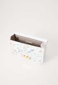White clutch bag with floral print, gold hardware, and a zippered inner pocket. Features a smooth texture and structured design.