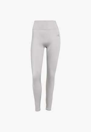Leggings alti di colore grigio chiaro con una texture liscia e elastica e un discreto logo del marchio sul lato sinistro.