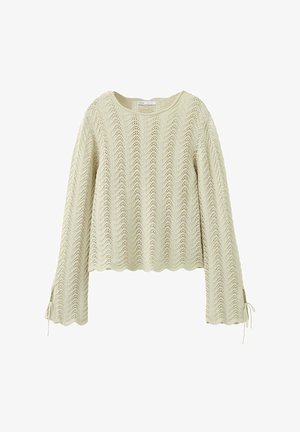 Kremowy, dziergany sweter z długimi rękawami z falistymi brzegami i wzorem koronki w jodełkę, z wiązaniami przy mankietach rękawów.