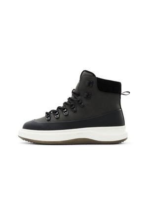 Black high-top boot with a smooth leather finish, featuring lace-up front, sturdy sole, and contrasting white midsole. Fitted ankle support.