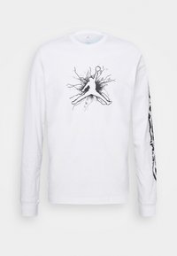 Valkoinen pitkähiha-puuvillainen T-paita, jossa musta graafinen kuva koripalloilijasta ja abstrakteja kuvioita hihoissa.