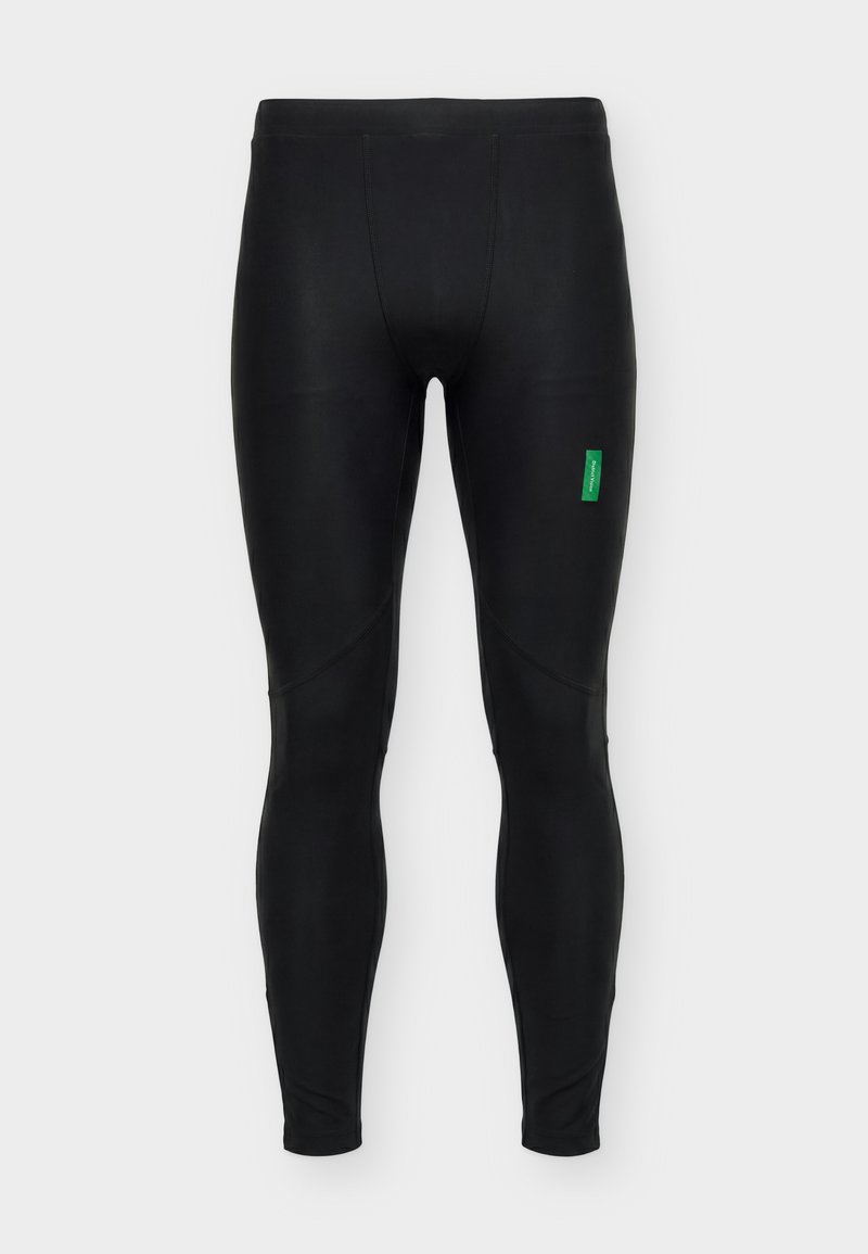 Legging de sport noir slim-fit avec des panneaux cousus aux genoux et un petit logo rectangulaire vert sur la partie supérieure de la cuisse gauche.
