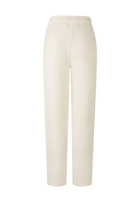 Crème-kleurige sweats met een zachte stof, voorzien van een elastische tailleband, taps toelopende benen en zonder zichtbare patronen of accenten.