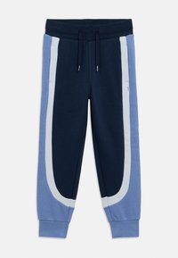 Μπλε ναυτικό και ανοιχτό μπλε παντελόνι φόρμας με λευκή λεπτομέρεια, διαθέτει ελαστική μέση, κορδόνι και στενό τελείωμα στα μπατζάκια. Απαλό, υφή υλικό.