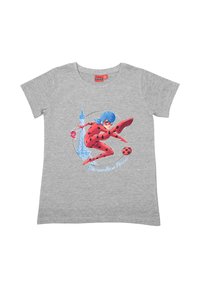 Girl in red and black polka dot superhero costume jumping with blue hair in front of Eiffel Tower outline and ladybug on gray shirt.