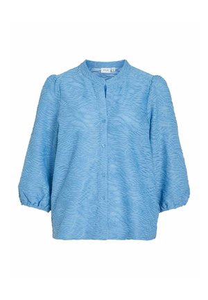 Šviesiai mėlyna mygtukų marškinėliai su tekstūriniu, banguotu raštu, pūsta savais ir be apykaklės dizainu. Minkšta medžiaga, turinti lengvą išvaizdą.