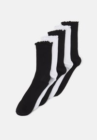 Five pairs of knee-high socks in black and white. The socks feature a ribbed texture and a ruffled cuff detail along the top.