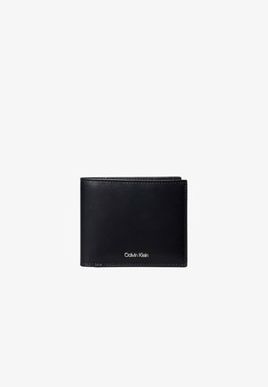 Portafoglio bi-fold in pelle nera con cuciture visibili e piccolo logo Calvin Klein in argento al centro frontale.