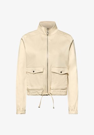 Veste beige zippée avec col montant, deux poches frontales à rabat avec boutons, cordon de serrage à l'ourlet et poignets élastiques aux manches longues.